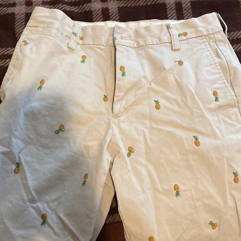 Khaki shorts with a little pineapples on it
